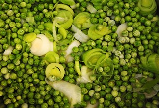 Sliced leek (Allium porrum) and green peas (Pisum sativum)