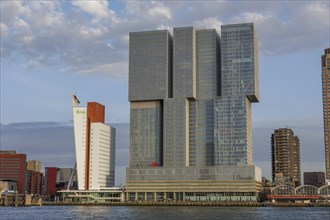 Large modern skyscrapers and buildings on the waterfront, cloudy sky, skyline of a modern city on