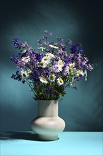 Vase with bouquet of wildflowers