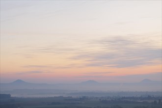 The three Kaiserberge mountains in the Swabian Alb. Sunrise with some fog. View from Aichelberg