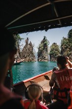 View from a boat of majestic limestone cliffs and clear water. Khao Sok National Park, Thailand,