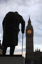 Winston Churchill statue silhouetted behind Big Ben at dusk, Bridge Street, SW1 London, England,