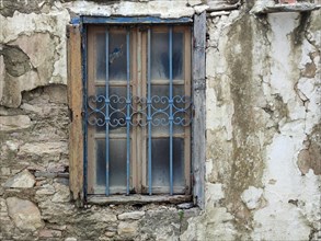 Dilapidated house facade, dilapidated window in a village on Rhodes, Dodecanese, Greek island,