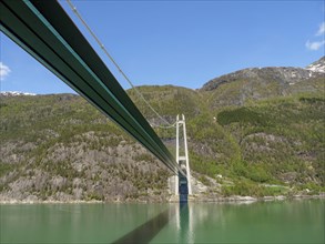 Panoramic shots of a bridge leading through a beautiful mountain landscape, bridge in a fjord with