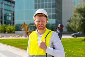 Portrait of a male adult caucasian architect with reflective waistcoat, helmet and draw tube