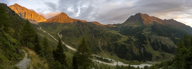 Panorama, rocky mountain peak Porze and green mountain landscape with river valley at sunrise,
