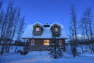 Cosy log cabin, log cabin at dusk, illuminated, winter, Brooks Range, Alaska, USA, North America