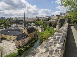 Panorama of a city wall with a view of a church, surrounding river and buildings in a spring-like