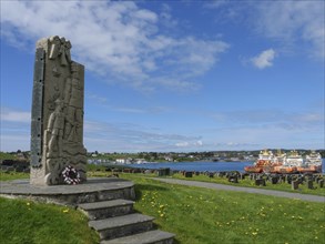 Stone memorial on a cemetery with a beautiful view of the water and the neighbouring boats, old