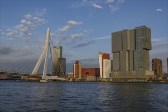 Modern bridge and skyscrapers on the river in daylight, Skyline of a modern city on the river with