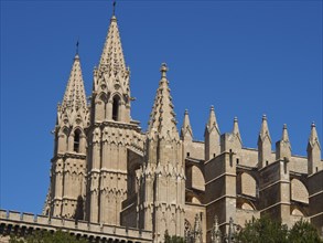 Gothic cathedral with two striking towers under a clear blue sky, beautiful cathedral with several