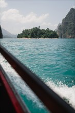Tranquil boat trip with views of calm waters and high cliffs. Khao Sok National Park, Thailand,