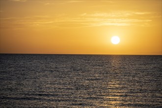 The sun sets behind the lake, sunset at Issyk Kul, Kyrgyzstan, Asia