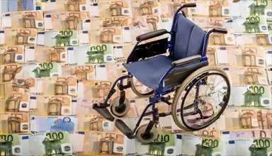 Symbolic photo, a wheelchair stands on a surface of euro notes, money, AI generated, AI generated