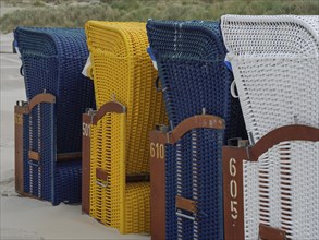 Close-up of colourful patterned beach chairs on the beachy shore, colourful beach chairs on the