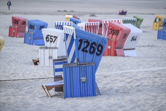 Blue beach with colourful beach chairs, relaxed atmosphere in typical beach holiday ambience, many