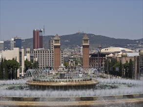 City view with central fountain and historical towers, with modern building background and
