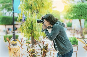 Male photographer taking photos in a public park, Nagarote. Photographer taking photos on the