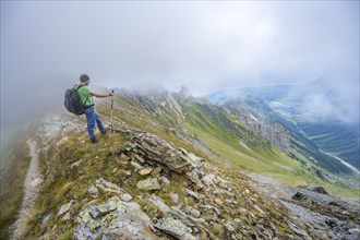 Mountaineer on a cloudy mountain ridge, Carnic Main Ridge, Carnic High Route, Carnic Alps,