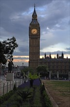Big Ben at dusk, Bridge Street, SW1, on the left the statue of Winston Curchill, London, England,