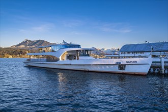 Modern boat on Lake Lucerne with mountains in the background under a blue sky, Lucerne,