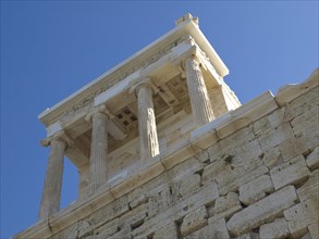 Ruins of an ancient temple with columns under a blue sky on the Acropolis, historical columns and