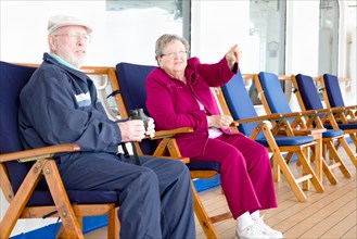 Senior adult couple enjoying the view from their passenger cruise ship deck