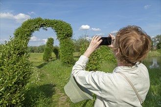 Woman photographed, Symphonic Willow Walk, Boizenburg, Mecklenburg-Vorpommern, Germany, Europe