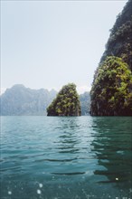 Tropical scenery with calm waters and sublime limestone cliffs. Khao Sok National Park, Thailand,