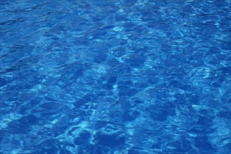Blue, clear and undulating water in an outdoor pool