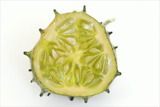 African horned melon (Cucumis metuliferus), sliced fruit on a white background