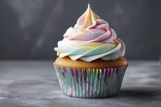 Cupcake with swirling pastel frosting on a matte grey backdrop, AI generated