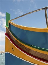 Close-up of a colourful boat with blue, red and yellow colours in sunny weather, many colourful
