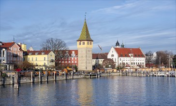 Harbour promenade with man tower, reflected in the lake, harbour, Lindau Island, Lake Constance,