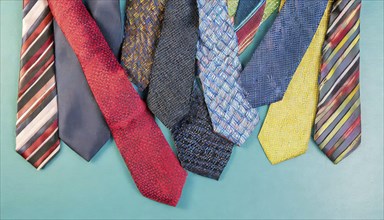 Different patterned and coloured ties on a light blue background, AI generated, AI generated