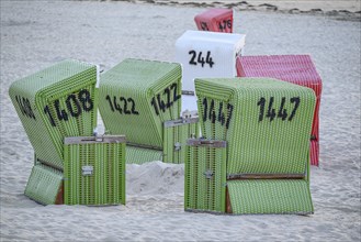 Colourful beach chairs on a sandy beach, orderly and resting with a view of the calm ocean, many