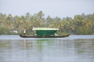 Indian man stakes his boat across the Cherai Lagoon, Vypin Island, Kochi, Kerala, India, Asia