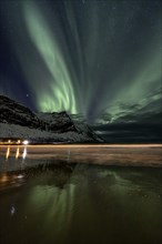 Green northern lights, aurora borealis, reflected in the sea, beach, coast, Senja, Troms, Norway,