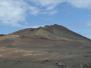 Fascinating volcanic landscape with barren soil and blue sky, barren landscape of lava mountains,