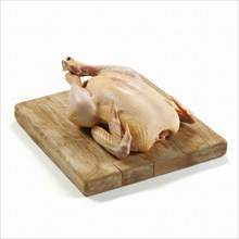 Raw whole chicken on a wooden cutting board, AI generated