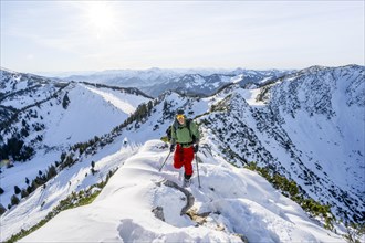 Mountaineer on the ridge of the Aiplspitz in the snow, snow-covered mountain landscape with