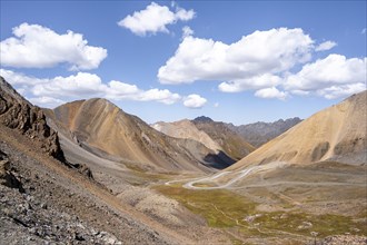 Mountain road through a colourful mountain landscape, view from the Chong Ashuu Pass, Tien Shan,
