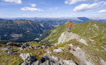 Mountaineer at the summit of Baerenbadegg, mountain panorama with view into the Dorfertal, Carnic