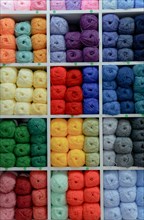 Colorful yarn and wool balls on display in a craft store
