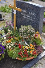 Grave with floral decoration at the cemetery church of St Stephan, Irsee, Swabia, Bavaria, Germany,