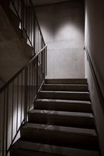 Modern Illuminated Concrete Staircase with Railing in Switzerland