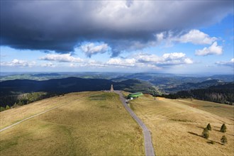 Vast landscape with green meadows and hills, spanned by dramatic clouds and blue sky, Feldberg,