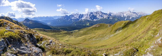 Green mountain meadows on a mountain ridge, mountain panorama, view of rocky mountain peaks of the