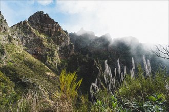 Mountain panorama with clouds through which rays of light break. Madeira, Portugal, Europe