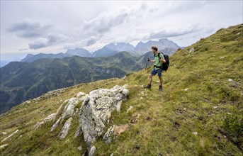 Mountaineer on a hiking trail in Niedergailtal, ascent to Obergailtaler Joch, Carnic Main Ridge,